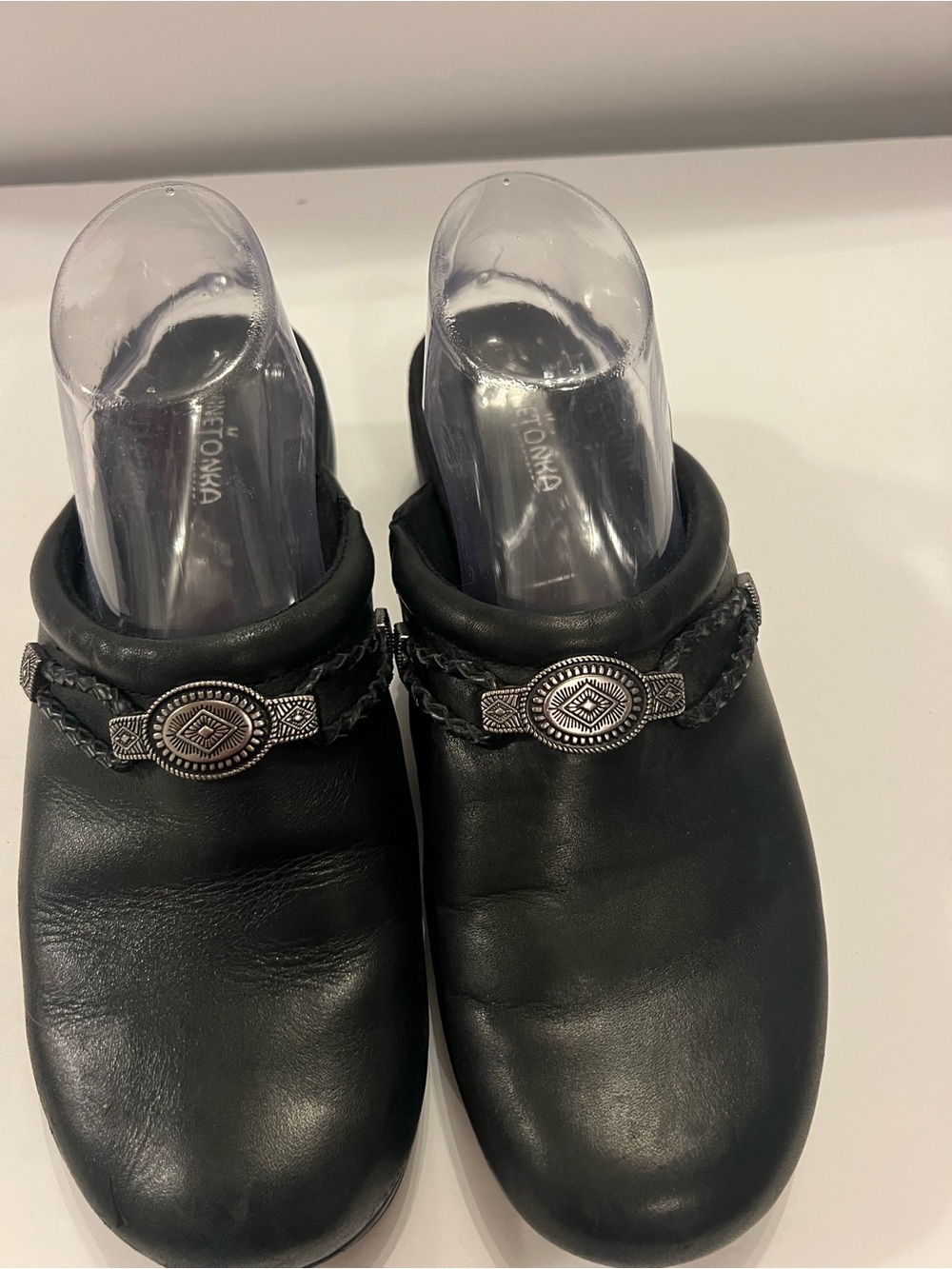 Minnetonka Black Leather Slip-On Mules with Braided Strap and Oval Concho